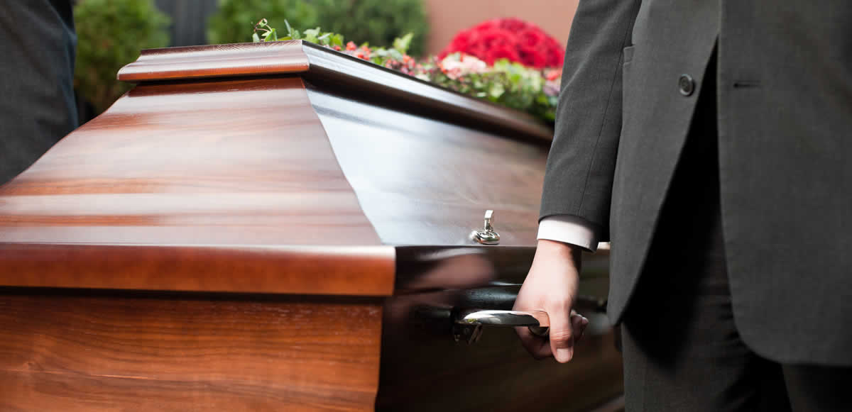 Man carrying coffin